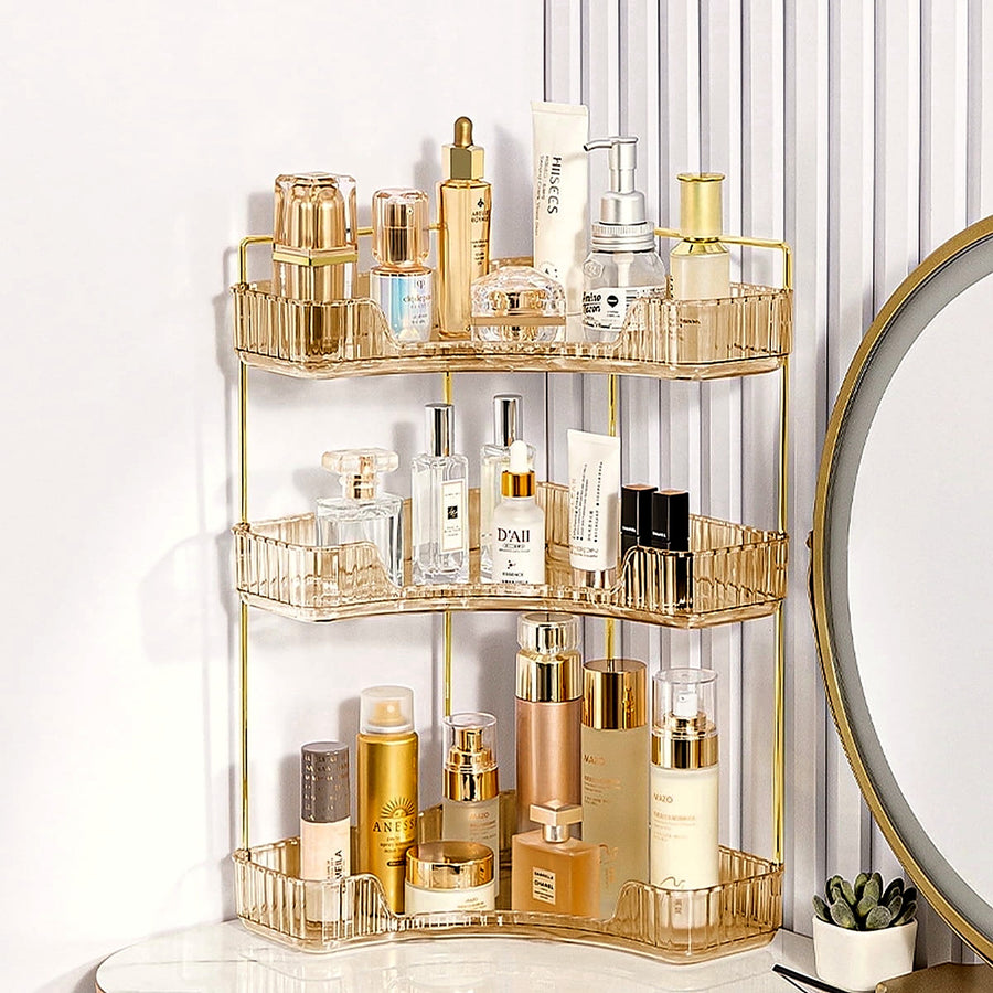 3-tier gold corner organizer holding perfume and skincare on a vanity