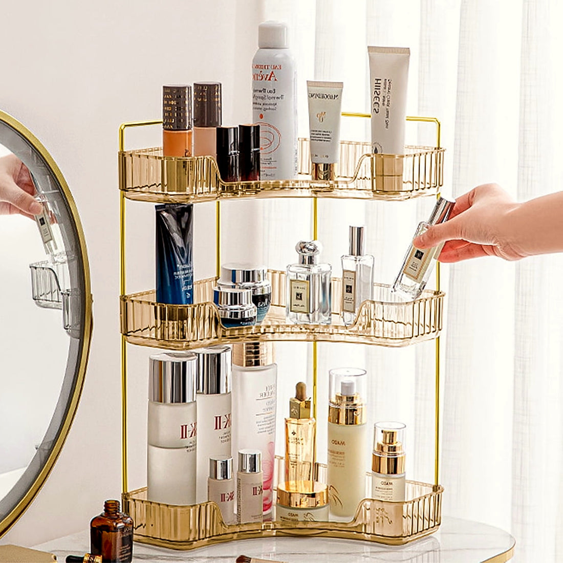 Reaching for a perfume bottle on the gold 3-tier corner organizer