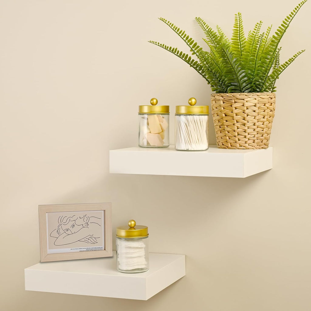 Gold-lid glass jars displayed on floating wall shelves